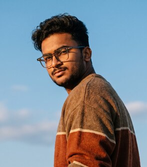 Yash Gandhi portrait against a blue sky