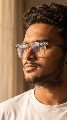 Side profile of Yash Gandhi by a window